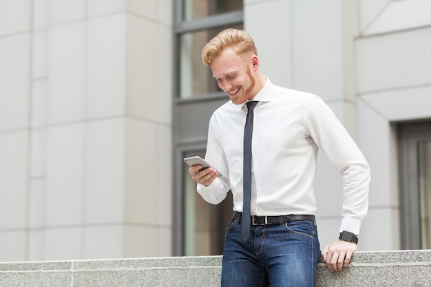 Redhead and bearded business man have a video conference in hes smart phone business concept