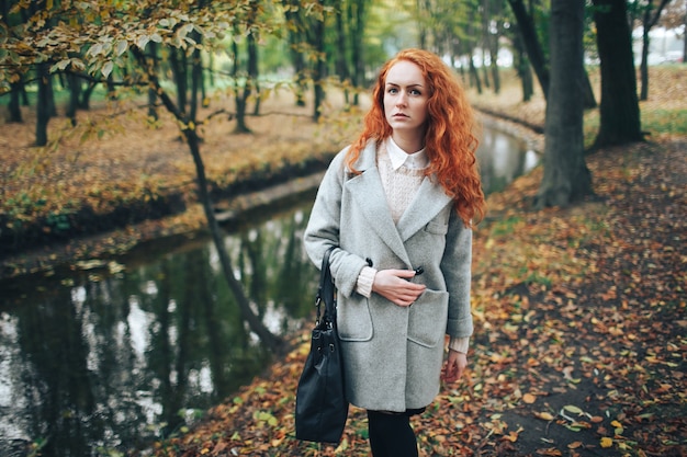 redhead girl in autumn park