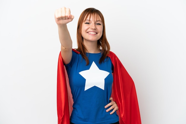 Redhead girl isolated on white background in superhero costume with proud gesture