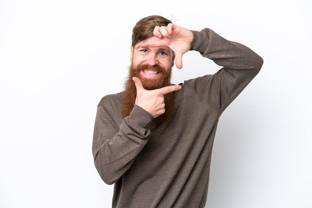 Redhead man with beard isolated on white background focusing face Framing symbol