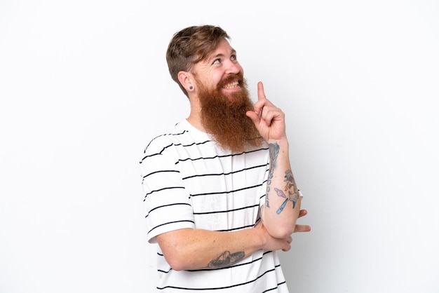 Redhead man with beard isolated on white background pointing up a great idea