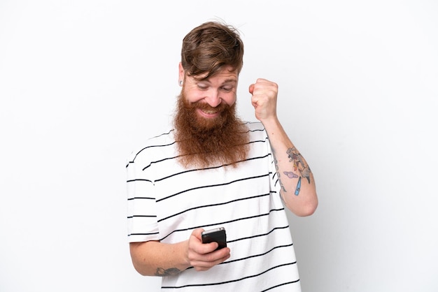 Redhead man with beard isolated on white background surprised and sending a message