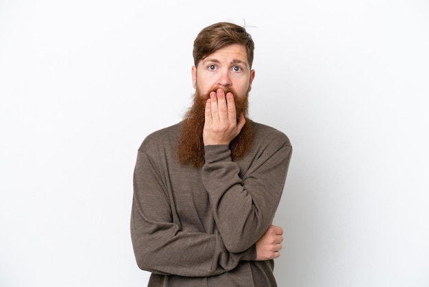 Redhead man with beard isolated on white background surprised and shocked while looking right