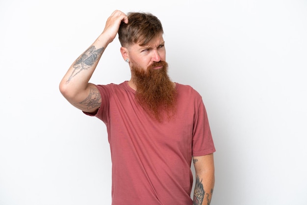 Redhead man with long beard isolated on white background having doubts while scratching head