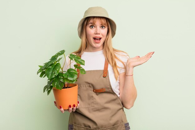 Redhead pretty woman feeling happy and astonished at something unbelievable gardener concept