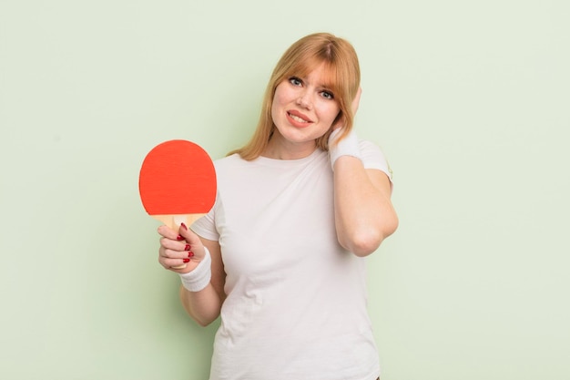 Redhead pretty woman feeling stressed anxious or scared with hands on head ping pong concept