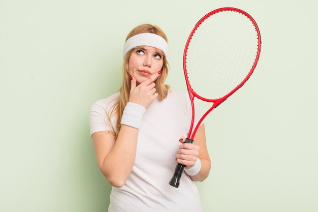 Redhead pretty woman thinking feeling doubtful and confused tennis concept