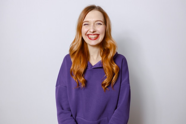 Redhead women laughing in purple hoodie