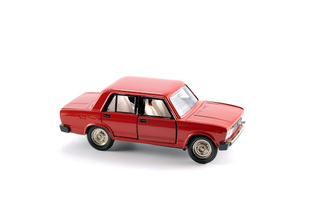 Reduced copy of the red car on a white background made of metal