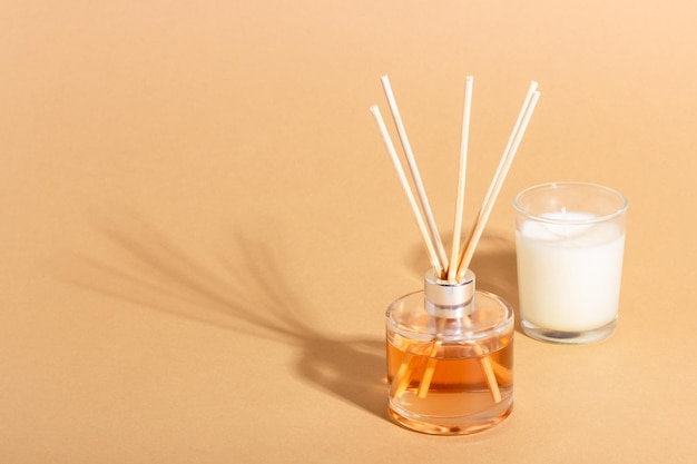 Reed diffuser bottle on a beige background Incense sticks for the home with a floral scent The concept of ecofriendly fragrance for the home