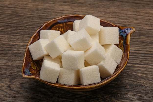 Refined white sugar cubs in the bowl