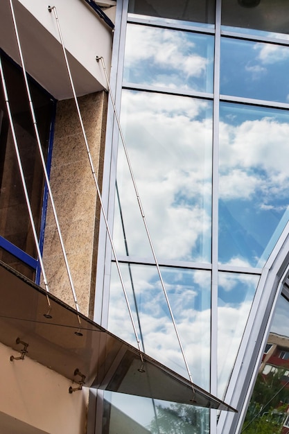 Reflecting clouds in mirrored windows of building