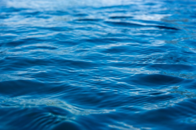 Reflection of blue water surface with small waves