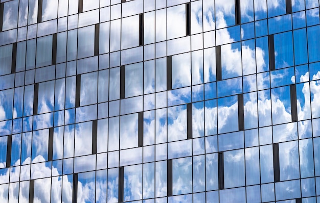 Reflection in the building blue sky with light clouds