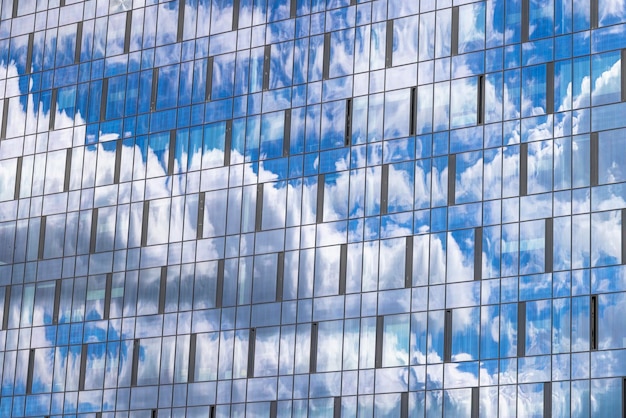 Reflection in the building blue sky with light clouds