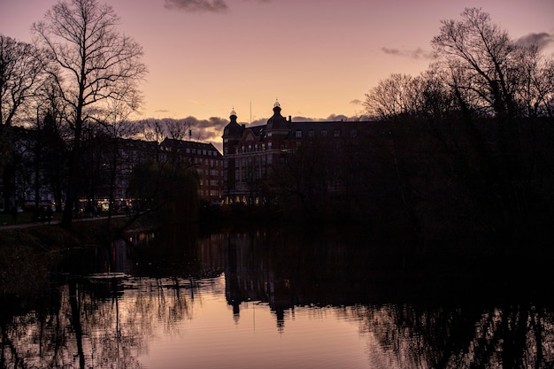 Photo reflection of buildings in lake at sunset