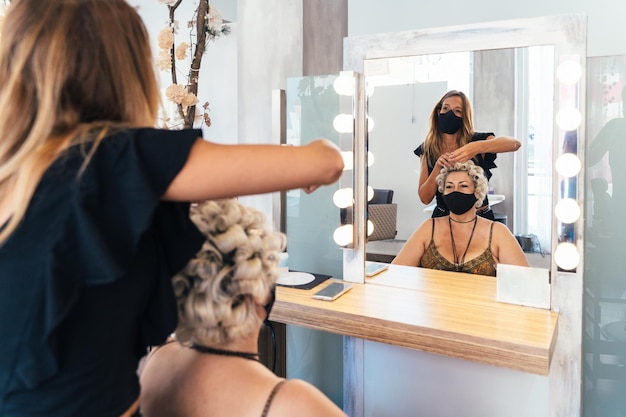 Reflection on the mirror of a hairdresser and a client