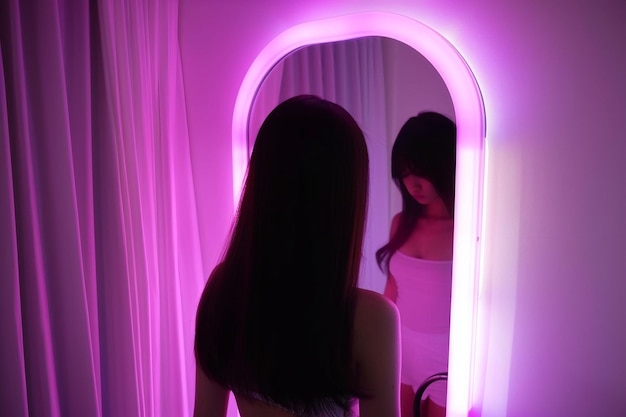 Photo reflection in a soft pink backlit mirror