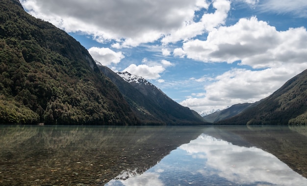 Reflections on a lake during sunny day photo taken at lake gunn fiordland national park new zealand