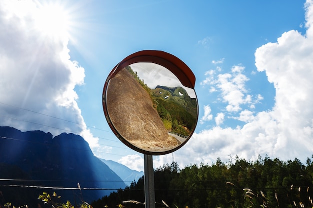 Reflections of the road on traffic mirror for traffic safety. Traffic mirror