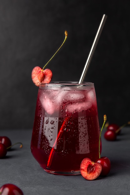 Refreshing cocktail with cherries and ice