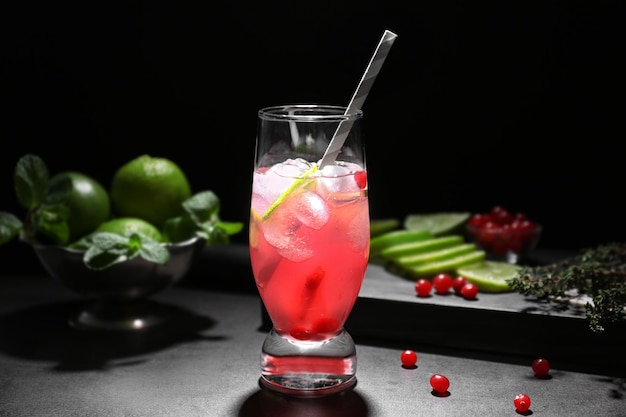 Refreshing cocktail with cranberry on dark table