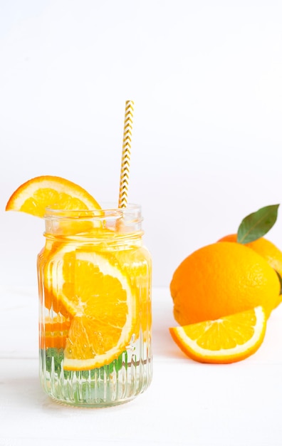 Refreshing cocktail with orange on white background