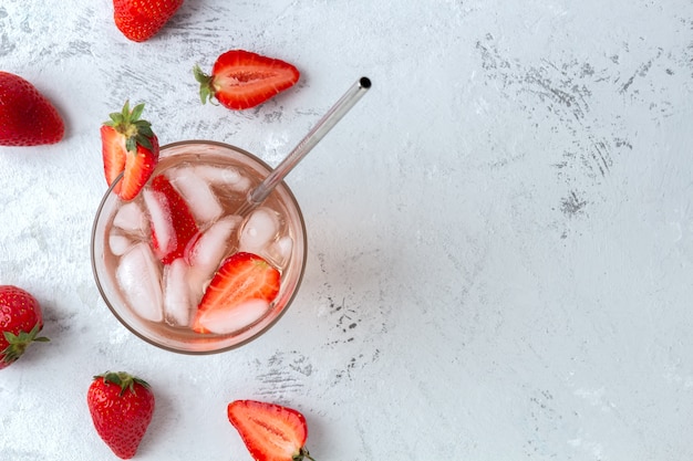 Refreshing cocktail with strawberries and ice cubes