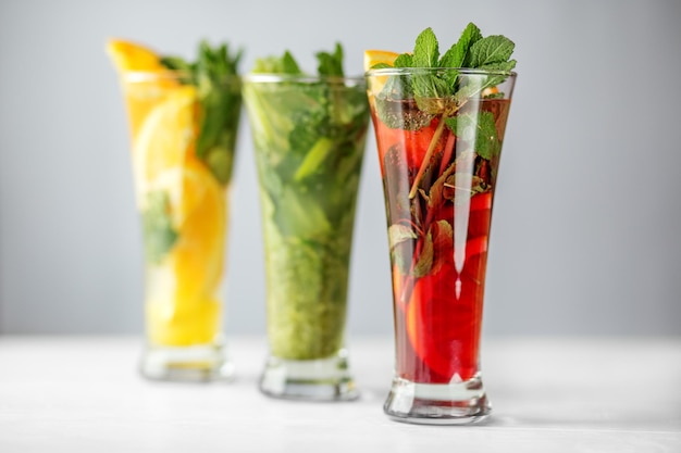 Refreshing cocktails with lime lemon and pomegranate and mint Concept for drinks summer heat alcohol party and bar