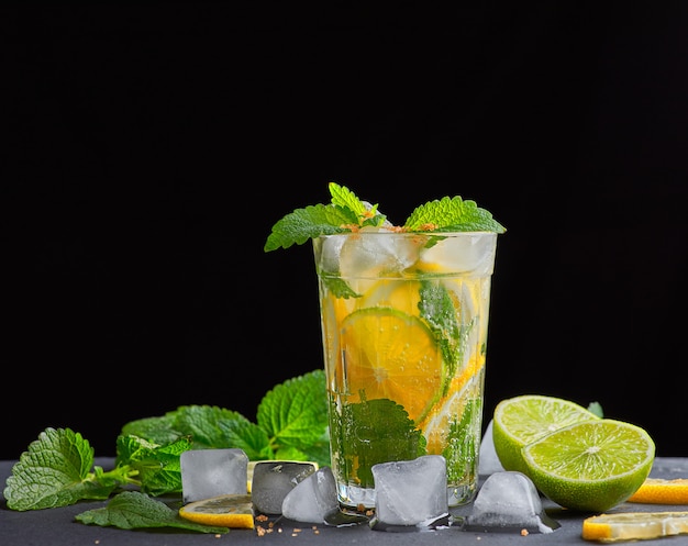  refreshing drink lemonade with lemons, mint leaves, ice cubes and lime