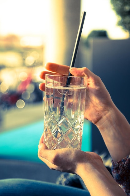 Refreshing drink in the summer Girl is holding glass with cold beverage