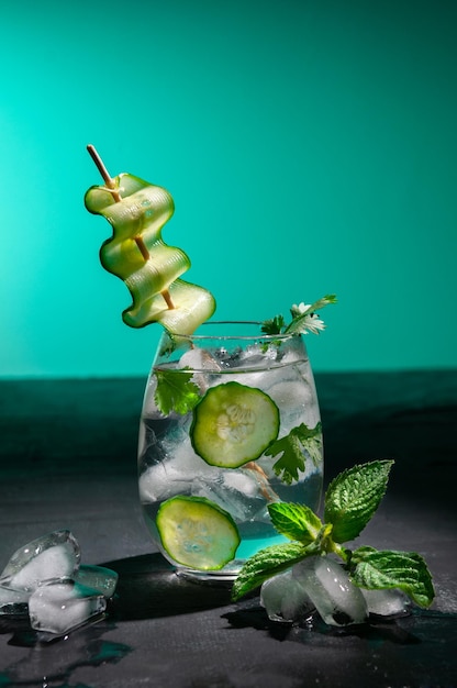 Refreshing drink with cucumber cilantro and ice in a tumbler Decorated with a slice of cucumber