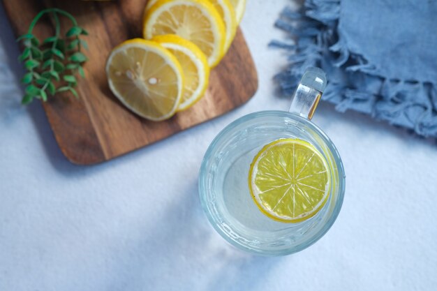 Refreshing drink with lemon on table  top view