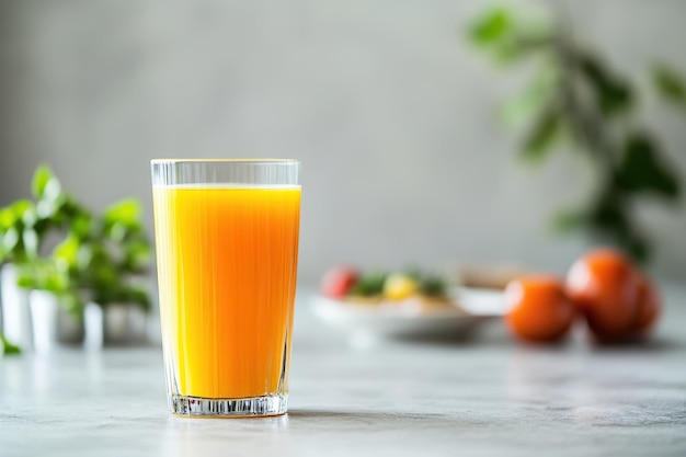 A refreshing glass of orange juice on a table with fruits and greenery in the background