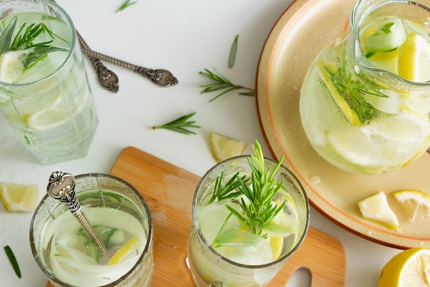 Refreshing iced drink with lemon and fresh rosemary