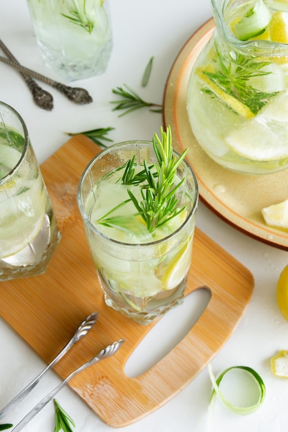 Refreshing iced drink with lemon and fresh rosemary