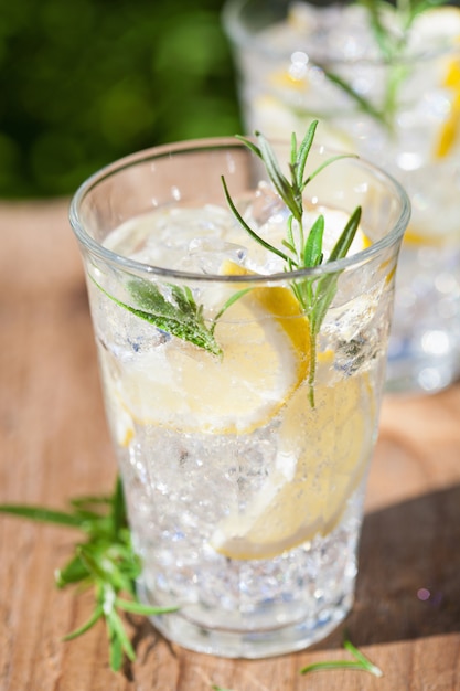 Refreshing lemonade drink with rosemary in glasses