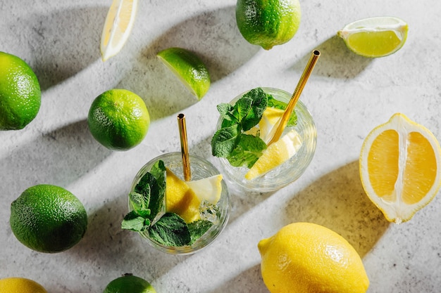 Refreshing lemonade or mojito cocktail with lemon and mint. Summer drinks.