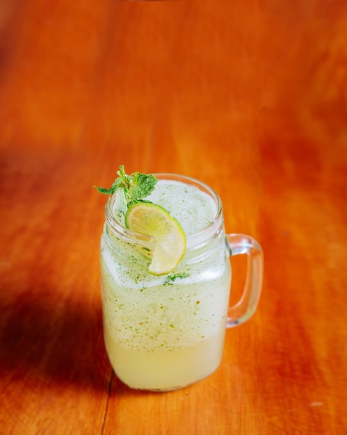 Refreshing lemonade with mint on wooden table Lemonade drink on wooden background