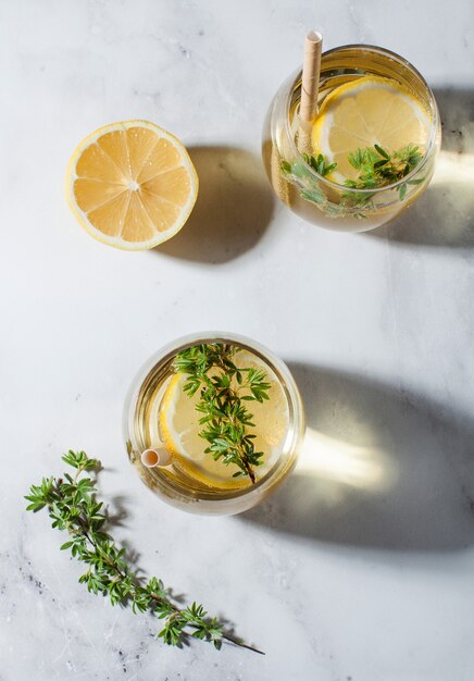 Refreshing lemonade with a slice of lemon a straw hard shadows