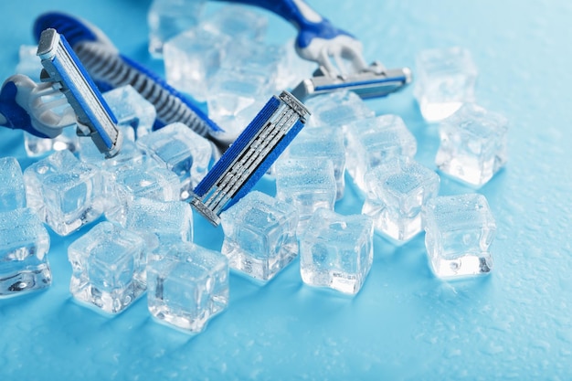 Refreshing shaving machines for the face against the background of frosty ice cubes