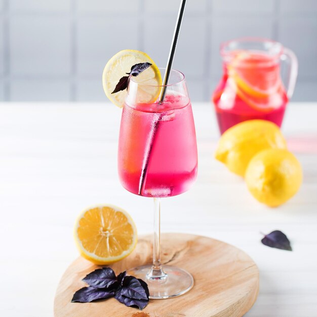 Refreshing summer drink in a glass red basil lemonade