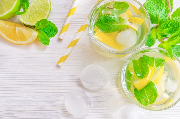 Refreshing summer drink mojito with lime, lemon and mint, with ice cubes 