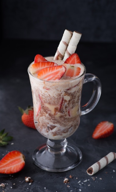 Refreshing summer ice cream with fresh strawberries and waffle straws Stilllife