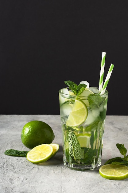 Refreshing summer mojito cocktail with ice cubes fresh mint and lime