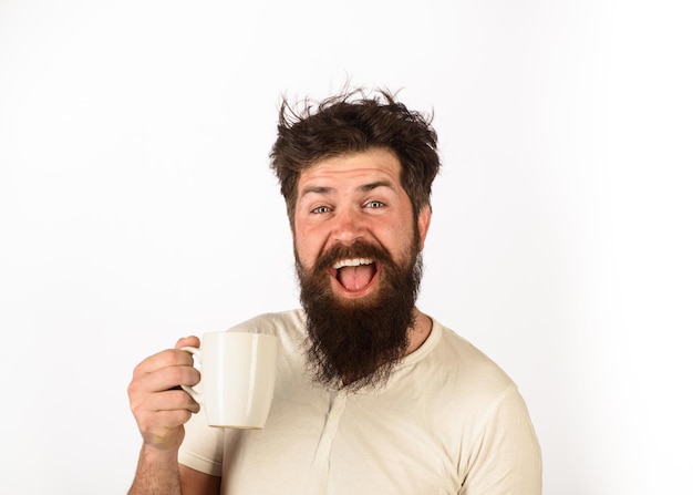 Refreshment and energy morning coffee concept cheerful man having cup of coffee in kitchen happy man