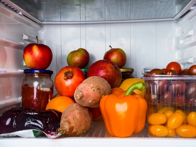 Refrigerator full of red and orange food