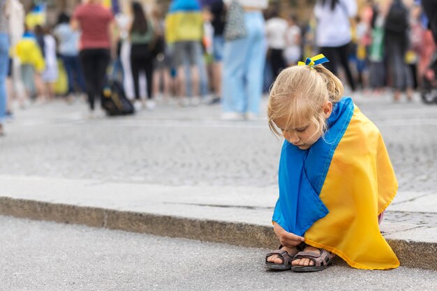 Refugees Ukraine Children on Support Rally in Europe Ukraine Child with the flag of Ukraine crying