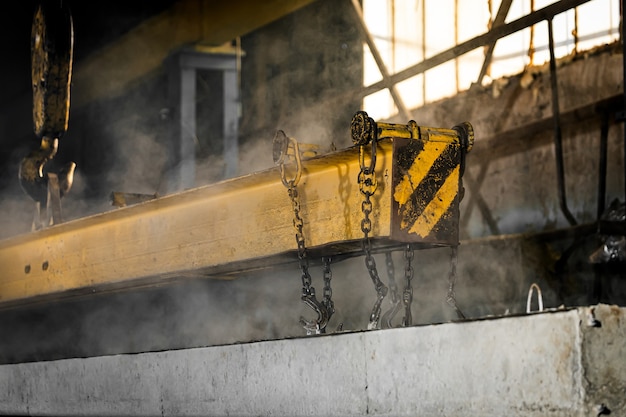 Reinforced concrete pillars fixed with metal hooks and chains