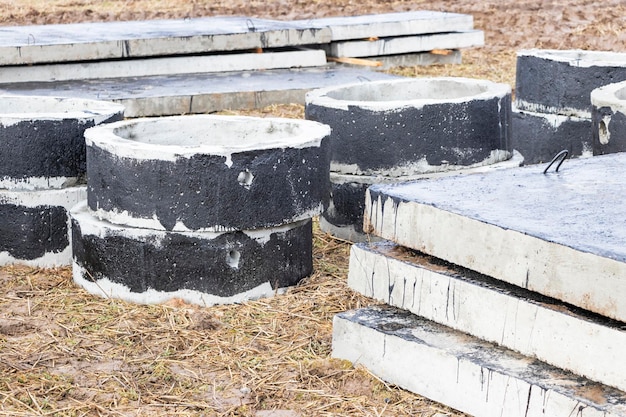 Reinforced concrete rings and slabs for wells on the construction site Preparation for the device of underground wells and communications Closeup